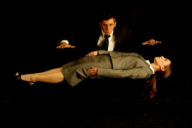 a magician levitating his assistant